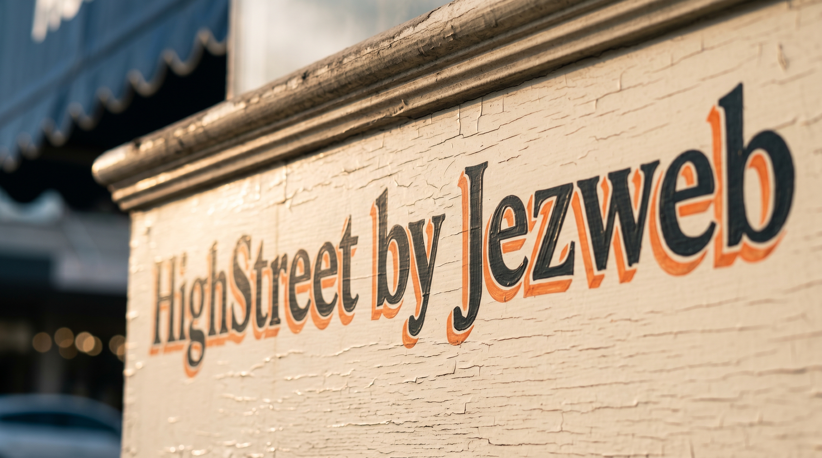 A traditional hand-painted high-street shopfront sign with afternoon light raking across